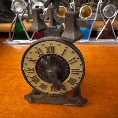 Sale Photo Thumbnail #44: Vintage cast iron mini clock sharpener novelty figure, featuring Roman numerals and top-mounted bells.
