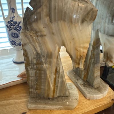 Sale Photo Thumbnail #21: Pair of carved onyx horse head bookends featuring stylized geometric manes and natural banded stone striations.