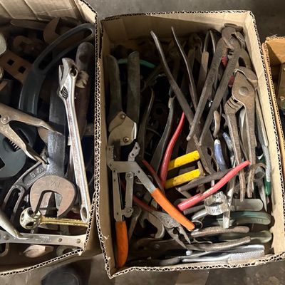 Sale Photo Thumbnail #78: Two cardboard boxes filled with assorted vintage hand tools, including pliers, adjustable wrenches, and specialty cutters.