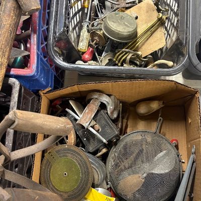 Sale Photo Thumbnail #85: Assorted vintage hand tools, hardware items, and kitchen gadgets stored in plastic crates and a cardboard box.