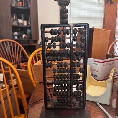 Sale Photo Thumbnail #33: Novelty table lamp repurposed from a vintage wooden abacus, featuring dark-stained beads and frame mounted on a matching wooden base.