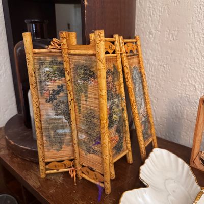 Sale Photo Thumbnail #16: Miniature Asian-style bamboo table screen featuring painted landscape artwork on woven reed panels.