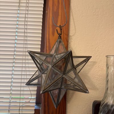 Sale Photo Thumbnail #6: Hanging leaded glass star pendant light or suncatcher with a metal metal frame, suspended by a wire hook.