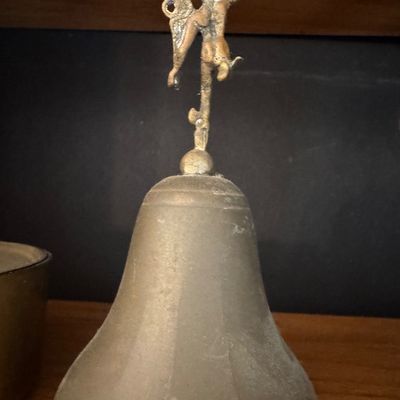 Sale Photo Thumbnail #42: Vintage brass hand bell featuring a winged Mercury finial top.
