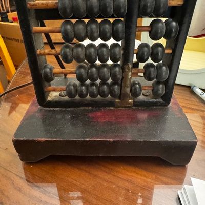 Sale Photo Thumbnail #32: Vintage wooden vertical abacus novelty table lamp with black frame and dark beads on a solid wood base.