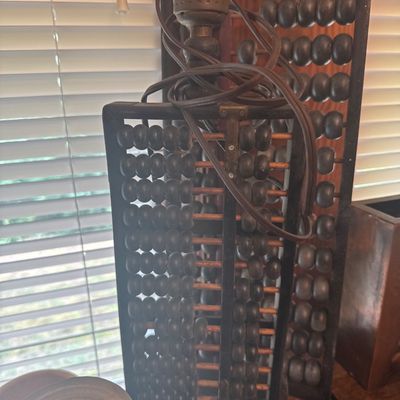 Sale Photo Thumbnail #34: Vintage table lamp made from a repurposed wooden abacus, featuring dark-stained wooden beads and a brass socket.
