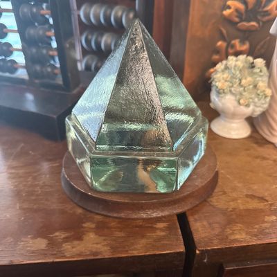 Sale Photo Thumbnail #37: Vintage heavy light-green glass prism insulator or paperweight mounted on a round wooden base.