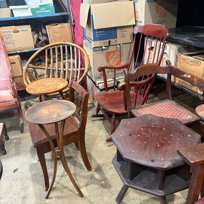 Sale Photo Thumbnail #57: Collection of vintage wooden furniture including small accent tables, a Windsor-style rocking chair, side chairs, and a rattan papasan chair.