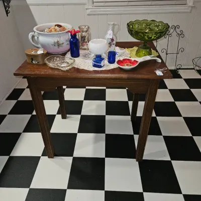 Sale Photo Thumbnail #66: Vintage dark wood accent table displaying various collectables, including an green glass pedestal bowl, a floral chamber pot, and cobalt blue glass pieces.