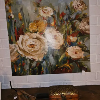 Sale Photo Thumbnail #30: Large unframed canvas painting depicting an impressionistic floral arrangement with cream-colored roses, displayed above a vintage woven box and a wooden shoe stretcher.