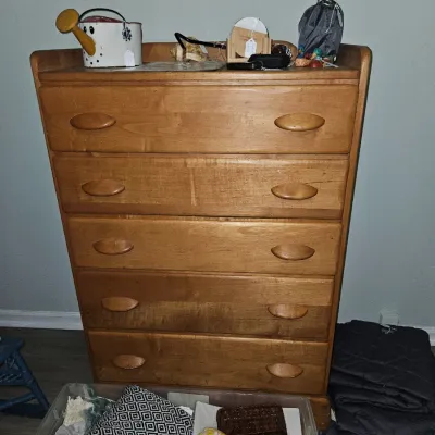 Sale Photo Thumbnail #48: Mid-century modern light maple tall dresser featuring five drawers with sculpted wooden pulls.