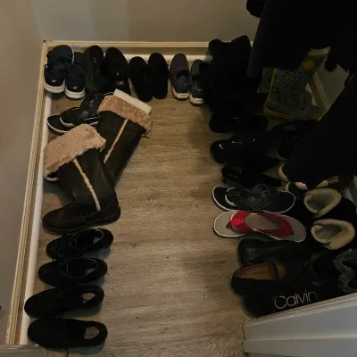 Sale Photo Thumbnail #70: Collection of women's shoes, boots, sandals, and slippers arranged on a wood-look floor inside a closet.