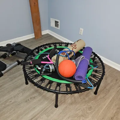 Sale Photo Thumbnail #45: Home fitness equipment assortment including a round mini-trampoline rebounder, a stair stepper machine, yoga mats, resistance bands, and a medicine ball.