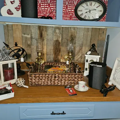Sale Photo Thumbnail #31: Collection of home decor items including decorative lanterns, a woven basket, brass sconce hurricane lamps, and a small black smart speaker.