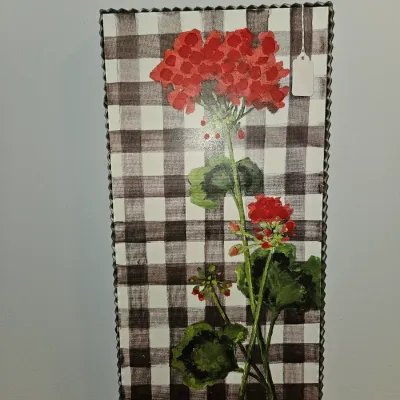 Sale Photo Thumbnail #19: Rustic farmhouse wall art depicting red geranium flowers over a black and white gingham pattern, set in a corrugated metal frame.