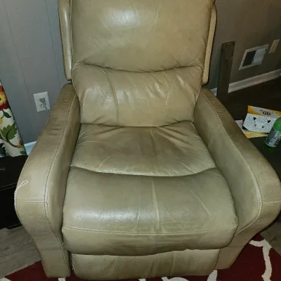 Sale Photo Thumbnail #51: Tan leather or faux leather padded recliner chair showing light wear.