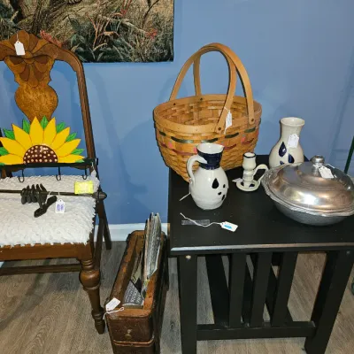 Sale Photo Thumbnail #10: Collection of home decor items featuring a wooden high-back dining chair, woven double-handle basket, salt-glazed stoneware pitchers, and a silver-tone covered serving dish.