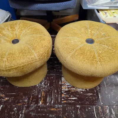 Sale Photo Thumbnail #185: Pair of vintage mid-century round mushroom-style ottomans with gold mustard yellow textured upholstery and central tufted buttons.