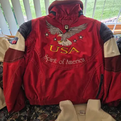 Sale Photo Thumbnail #283: Vintage red USA Spirit of America ski jacket featuring embroidered bald eagle graphic and US Ski Team arm patch.