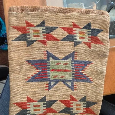 Sale Photo Thumbnail #270: Hand-woven wool textile bag featuring Southwestern geometric star motifs in red, blue, green, and cream tones.