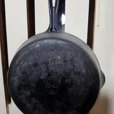 Sale Photo Thumbnail #200: Vintage Griswold cast iron skillet No. 8 with small logo trademark, displaying natural patina and light surface wear.