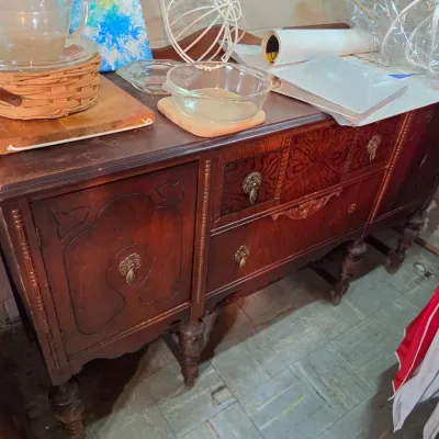 Sale Photo Thumbnail #210: Antique Jacobean-style dark wood sideboard featuring decorative wood overlays, turned legs, and metal drop handles.