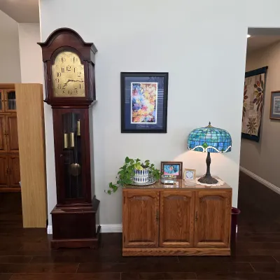 Sale Photo Thumbnail #16: Traditional wooden grandfather clock with pendulum and decorative dial.
