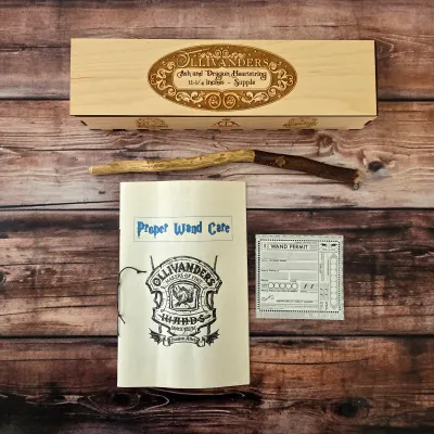 Sale Photo Thumbnail #53: Harry Potter collectible wand with Ollivanders box and wand-care booklet.