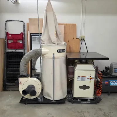 Sale Photo Thumbnail #70: Shop Fox woodworking dust collector with collection bag and flexible hose.