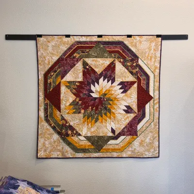 Sale Photo Thumbnail #97: Handmade star medallion wall quilt in burgundy, gold and cream.