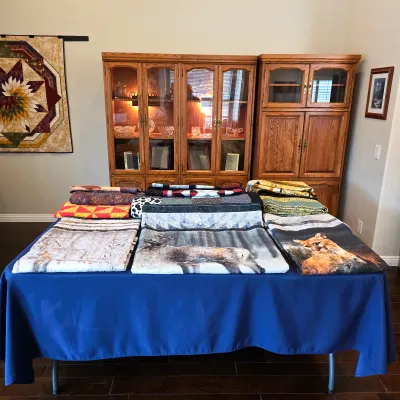 Sale Photo Thumbnail #3: Handmade quilts from Cathy’s collection, featuring detailed quilting, patchwork and wildlife designs.