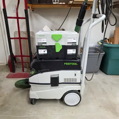 Sale Photo Thumbnail #78: Festool CT 26 E dust extractor with hose and stacked tool storage.