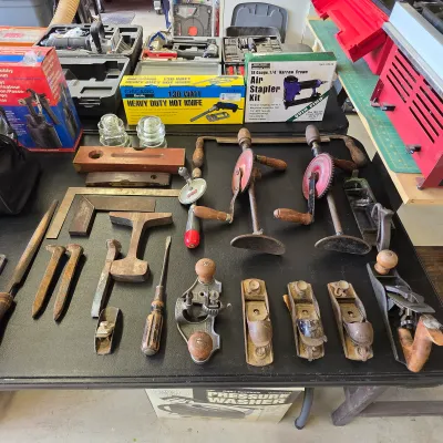 Sale Photo Thumbnail #245: Vintage woodworking hand tools including hand planes, brace drills, chisels and mallets.
