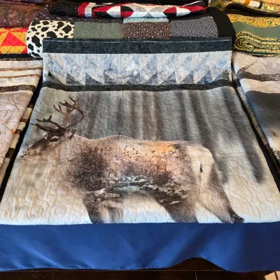 Sale Photo Thumbnail #109: Handmade elk wildlife quilt with woodland imagery and decorative quilting.