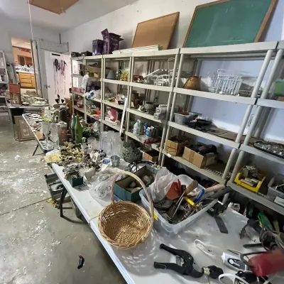 Sale Photo Thumbnail #32: Workshop and garage organization featuring plastic shelving units filled with various tools, glassware, small decor items, and household goods.