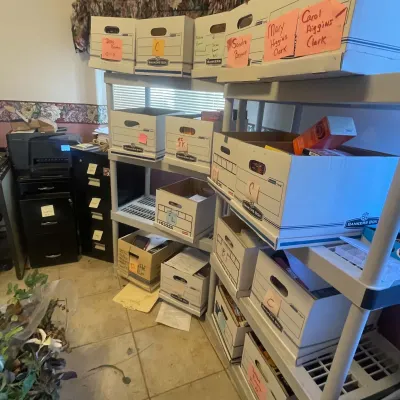 Sale Photo Thumbnail #80: Plastic shelving units filled with labeled Bankers Box storage cartons containing books and documents in a home office.