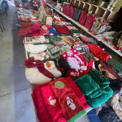 Sale Photo Thumbnail #131: Large assortment of holiday linens and Christmas decor, including hand towels, plush snowmen, placemats, and tree skirts.