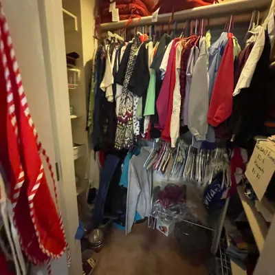 Sale Photo Thumbnail #68: Closet filled with assorted men's and women's clothing, hangers, and linens.