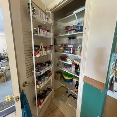 Sale Photo Thumbnail #9: White wire over-the-door spice rack organizing various kitchen seasonings alongside a pantry filled with plastic food storage containers and cookery items.