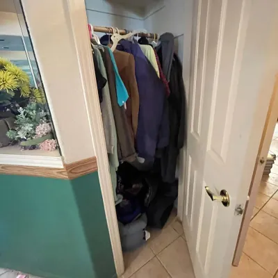 Sale Photo Thumbnail #64: Small coat closet filled with various winter jackets, coats, and accessories.