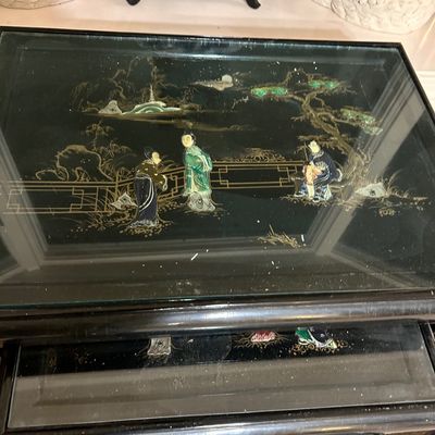 Sale Photo Thumbnail #44: Vintage Asian black lacquer nesting tables with glass tops and inlaid mother-of-pearl figural scenes.