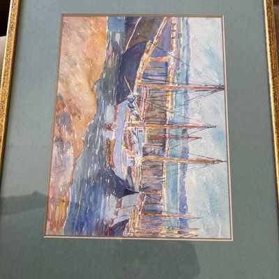 Sale Photo Thumbnail #179: Framed watercolor painting depicting tall ships and sailboats docked in a harbor, presented in a green mat and textured gold-tone frame.