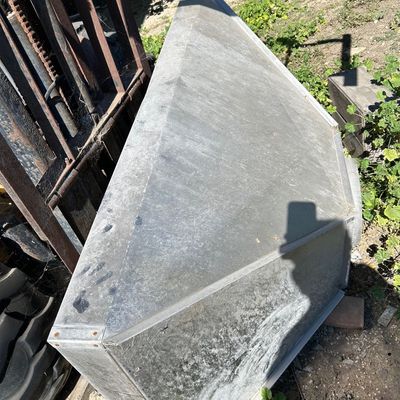 Sale Photo Thumbnail #131: Large galvanized sheet metal vent hood, resting outdoors near industrial equipment.