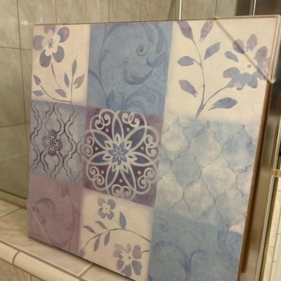 Sale Photo Thumbnail #20: Square canvas wall art featuring a grid of muted blue and lavender floral, scroll, and geometric tile patterns, still in original protective plastic corner guards.