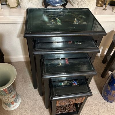 Sale Photo Thumbnail #43: Vintage Asian black lacquer nesting tables with glass tops and inlaid mother-of-pearl or soapstone figurative scenes.