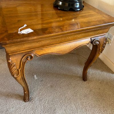 Sale Photo Thumbnail #189: French Provincial style wooden end table with carved cabriole legs and a polished veneer top.