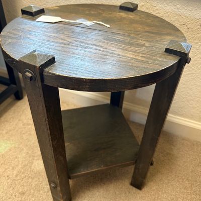 Sale Photo Thumbnail #117: Rustic dark wood round end table featuring pyramid stud leg caps and a lower shelf.