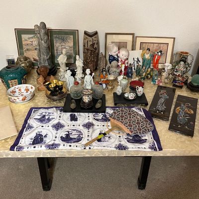 Sale Photo Thumbnail #81: Large collection of Asian decor and collectibles, including porcelain figurines, snuff bottles, lacquer art panels, framed artwork, and a Dutch-motif textile.