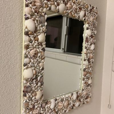 Sale Photo Thumbnail #73: Handcrafted rectangular wall mirror with a densely detailed frame covered in various natural sea shells.