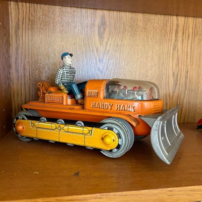Sale Photo Thumbnail #112: Vintage Handy Hank No. 112 tin litho toy bulldozer with driver figure, mid-20th century.